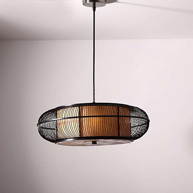 Caged circular pendant light in black or beige